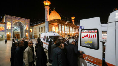 Emergency personnel transport the injured following a shooting attack at Iran's Shah Cheragh mausoleum