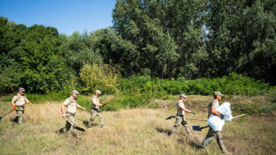 Romanian soldiers build a bomb shelter for residents in the village of Plauru near the border with Ukraine