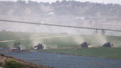 A picture taken from southern Israel along the border with the Gaza Strip shows Israeli army tanks and buldozers crossing the border into Gaza, on October 29, 2023