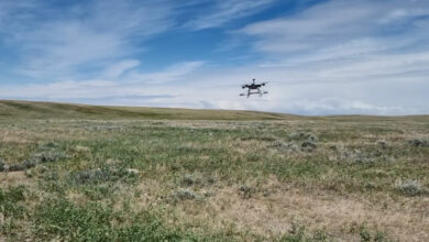 Drone flying above a field.