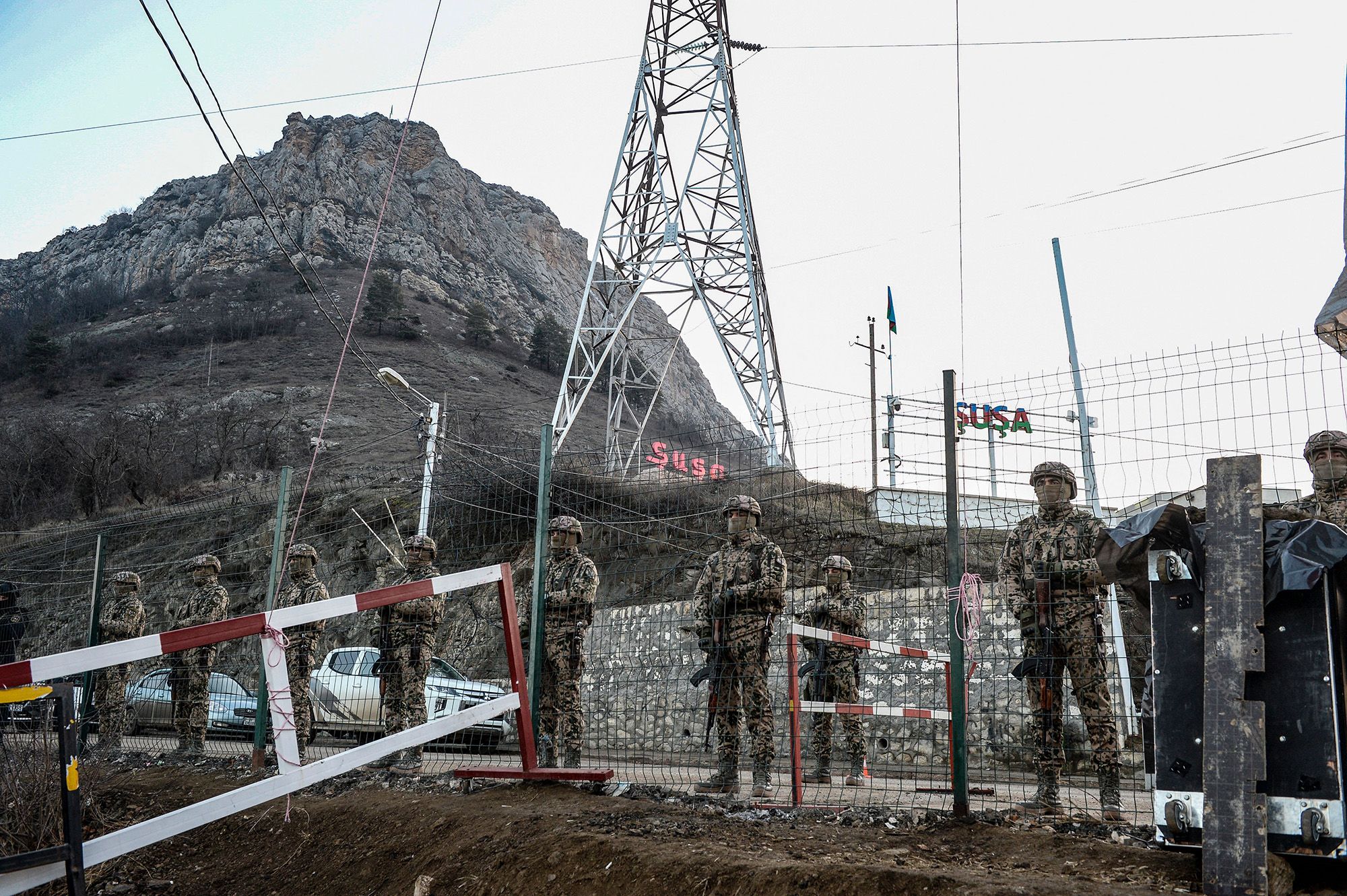 Azerbaijani servicemen stand guard at a checkpoint at the Lachin corridor, which links the disputed Nagorno-Karabakh region with Armenia