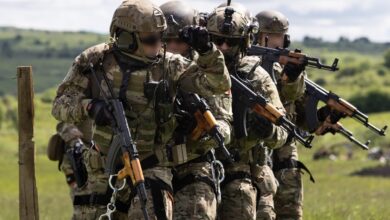 Romanian Special Forces operators prepare to execute a simulated breach during exercise Steadfast Defender 2021.