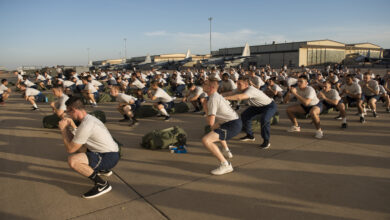 Airmen in the 363rd Training Squadron, perform squats during a physical training (PT) session at Sheppard Air Force Base, Texas, Nov. 30. PT sessions are led by military training leaders (MTL) to ensure Airmen are using proper form during their exercises. (U.S. Air Force photo by Alan R. Quevy)