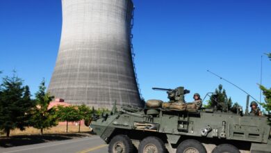 M1135 Reconnaissance Vehicle team conducting hazardous response drill at a nuclear power plant area.