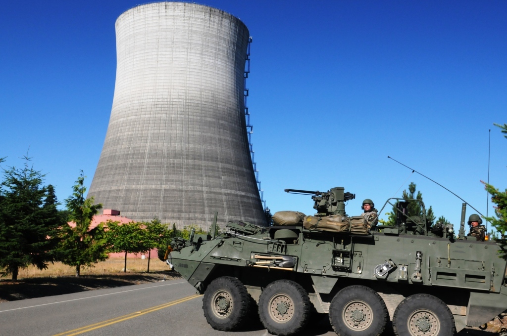 M1135 Reconnaissance Vehicle team conducting hazardous response drill at a nuclear power plant area.