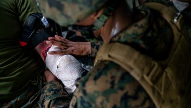 U.S. Navy Hospital Corpsman 3rd Class Matthew Watts with Naval Family Branch Clinic Iwakuni, and a native of California, wraps gauze on a simulated casualty during a mass casualty exercise at Marine Corps Air Station Iwakuni, Japan, June 11, 2024. The exercise was performed to rehearse emergency response procedures and enhance both readiness and efficiency when responding to mass casualty incidents. (U.S. Marine Corps photo by Sgt. Raymond Tong)