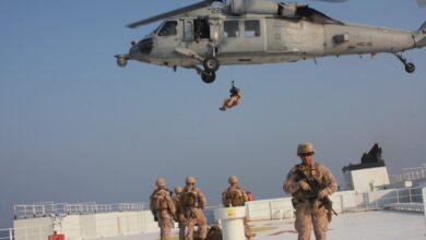 Marines assigned to Fleet Anti-Terrorism Security Team, Central Command prepare to be extracted by a Navy MH-60S Seahawk, attached to Helicopter Sea Combat Squadron 26 (HSC-26) from the Arc Liberty, a Military Sealift Command time chartered vessel, after providing security during a Strait of Hormuz transit