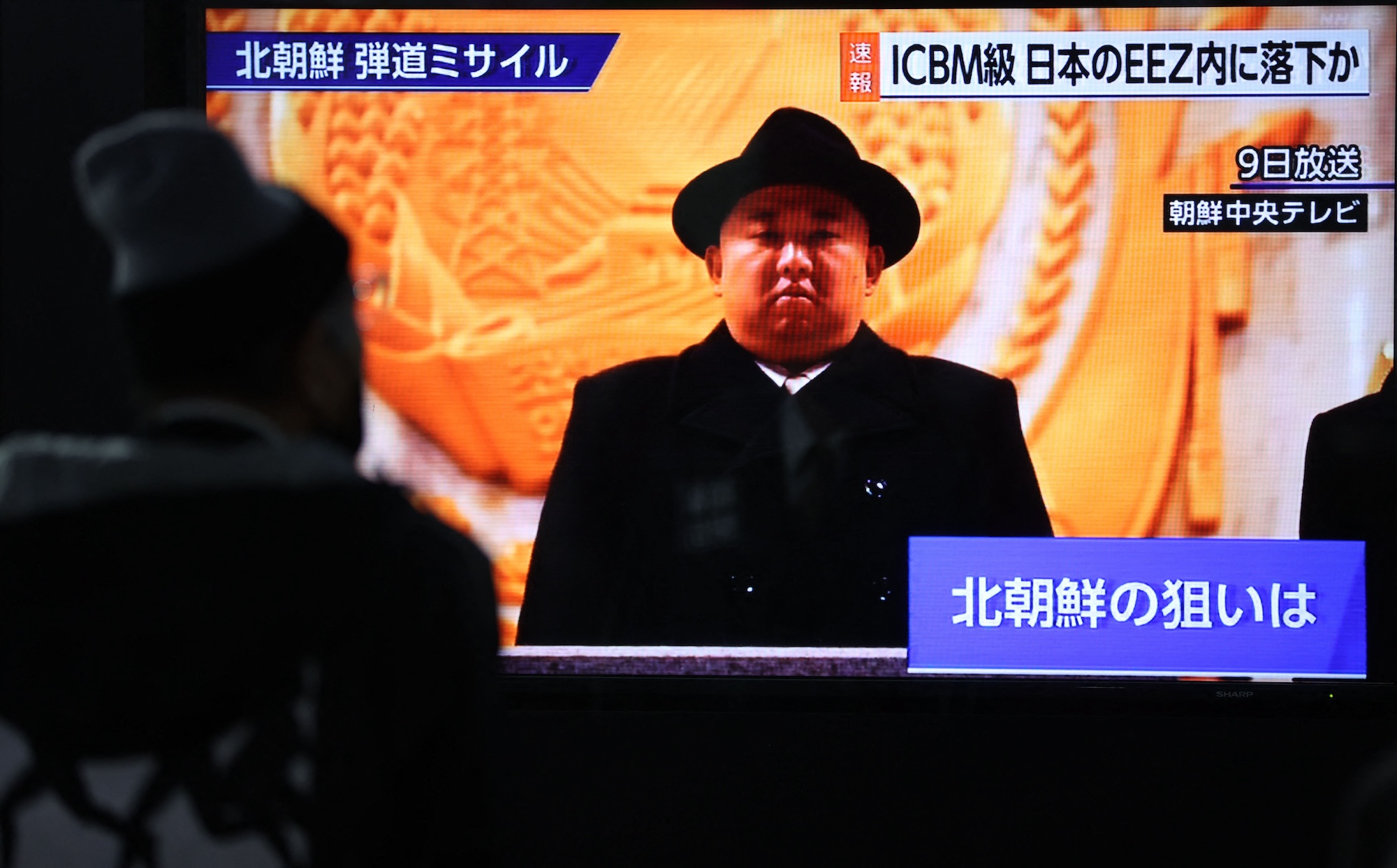 A screen monitor shows North Korean leader Kim Jong Un