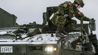 Canadian Army Bombardier Brett Beauchemin, an airspace coordination centre technician assigned to 4th Artillery Regiment, positions a side-view mirror on a light armoured vehicle during Exercise ARCTIC EDGE 2022 at Eielson Air Force Base, Alaska, Mar. 6, 2022. Arctic Edge is the largest joint exercise in Alaska, with approximately 1,000 U.S. military personnel training alongside members of the Canadian Armed Forces. (U.S. Air Force photo by Senior Airman Joseph P. LeVeille)