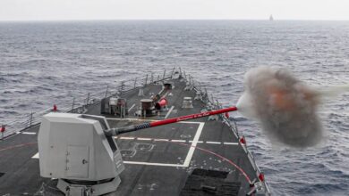 The Arleigh Burke-class guided-missile destroyer USS Rafael Peralta (DDG 115) fires its Mk 45 5-inch gun.