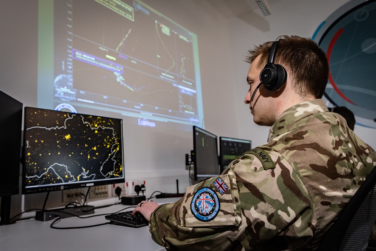 Soldier operating a command, control, and command, control, and data processing station for military satellites
