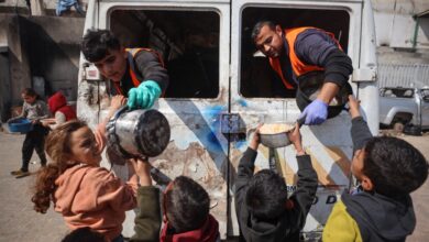 Palestinians gather to receive aid food distributed by charitable hospices in Gaza City, Palestine, on February 14, 2025.