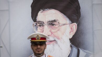 A member of an Iranian Army honor guard stands at attention in front of a portrait of Iran's Supreme Leader, Ayatollah Ali Khamenei, during a ceremony