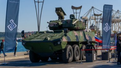 The Mangart 30 remote-controlled turret, integrated on a Patria 8x8 Armored Modular Vehicle. Two banners displaying Valhalla's logo are propped up on the vehicle's sides. The capability was unveiled during the Armed Forces Day celebration in Koper, southwest Slovenia.