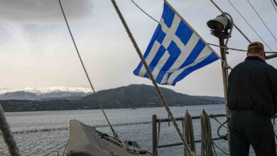 240229-N-ED646-1045 SOUDA BAY, GREECE (Feb. 29, 2024) Quartermaster 1st Class Brandon Gould, assigned to the Harpers Ferry-class dock landing ship USS Carter Hall (LSD 50), hoists up the Greek flag as the ship pulls into Souda Bay, Greece for a scheduled port visit, Feb. 29. Carter Hall is on a scheduled deployment in the U.S. Naval Forces Europe area of operations, employed by the U.S. 6th Fleet to defend U.S., Allied and partner interests. (U.S. Navy photo by Mass Communication Specialist 2nd Class Moises Sandoval)