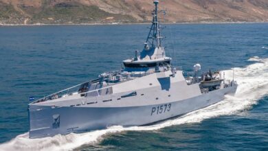 South African Navy's Multi-Mission Inshore Patrol Vessel (MMIPV), P1573, is seen sailing in deep blue waters. The ship is painted gray, with 'P1573' painted on the left side of its hull in black.
