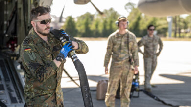 A German military member carries a fuel hose at Moody Air Force Base, Georgia, Oct. 23, 2024. Forward Area Refueling Point techniques utilize specialized equipment and small groups of trained military members to rapidly refuel aircraft in austere locations. (U.S. Air Force photo by Senior Airman Leonid Soubbotine)