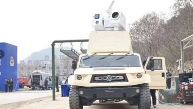 The Silent Hunter laser air defense system is seen installed atop an SUV-type vehicle. The system and vehicle are both painted dirty white.