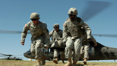 Soldiers from the 154th Transportation Company, 180th Transportation Battalion, 15th Sustainment Brigade, 13th Sustainment Command (Expeditionary), carry a fellow Soldier away from a medical evacuation helicopter during medevac training on Oct. 2, 2008, at Fort Hood.
