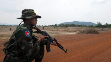 A Royal Cambodian Armed Forces soldier reacts to a simulated improvised explosive device hidden inside bushes along the roadway during Counter-IED training at the Peacekeeping Operations School in Kampong Speu province, March 15. Idaho Army National Guard soldiers partnered with RCAF during Angkor Sentinel 2012, an annual bilateral military exercise sponsored by U.S. Army Pacific and hosted by Cambodian forces.