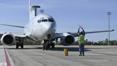 A Royal Australian air force maintainer signals to an E-7 Wedgetail to stop after reaching its parking area after completing a scenario during Checkered Flag 24-1 at Tyndall Air Force Base, Florida, Nov. 1, 2023. Checkered Flag is a large-force aerial exercise held at Tyndall Air Force Base which fosters readiness and interoperability through the incorporation of 4th and 5th-generation aircraft during air-to-air combat training. (U.S. Air Force photo by Staff Sgt. Jake Carter)