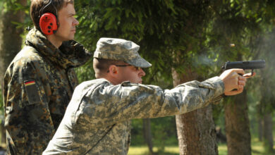 U.S. Army Spc. Andrew Maclaren, assigned to U.S. Garrison Grafenwoehr, fires the German P8 pistol under the guidance of German Army Oberleutnant Kay Schwotzer during the qualification for the Schuetzenschnur, the German Armed Forces Badge of Weapon's Proficiency, at the 7th Army Joint Multinational Training Command's Grafenwoehr Training Area, Germany, July 30, 2013. (U.S. Army photo by Visual Information Specialist Markus Rauchenberger/released)