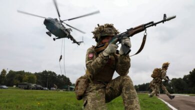 A Ukrainian soldier holding a rifle.