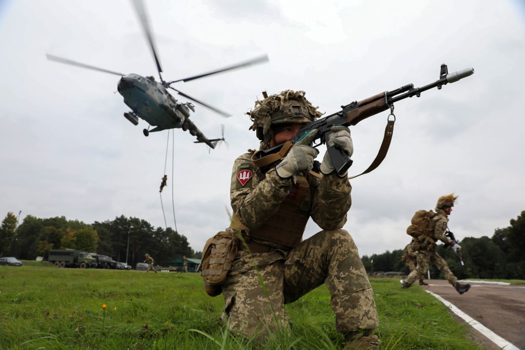 A Ukrainian soldier holding a rifle.