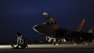 U.S. Air Force Airman 1st Class Aaron Tate enters data into his portable maintenance computer in front of an F-22A Raptor aircraft at Kadena Air Base, Japan, on Jan. 21, 2009. Tate and the jet are deployed from the 27th Fighter Squadron at Langley Air Force Base, Va. (DoD photo by Master Sgt. Andy Dunaway, U.S. Air Force. (Released))