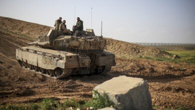 Israeli military forces patrolling on a tank near Gaza