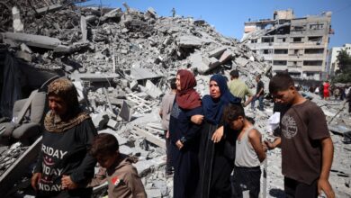 Palestine residents crying and walking over a rubble of a building after an Israeli strike