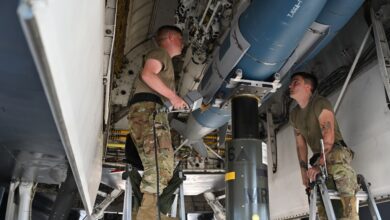 Members of the 28th Aircraft Maintenance Squadron weapons load crew insert an inert joint air-to-surface standoff missile into a B-1B Lancer.
