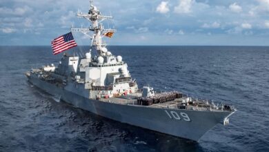 Sailors aboard the Arleigh-Burke class guided-missile destroyer USS Jason Dunham (DDG 109) pose for a command photo Dec. 2, 2018.