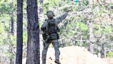 A soldier tosses a Sim Grenade in operational testing at the Joint Readiness Training Center
