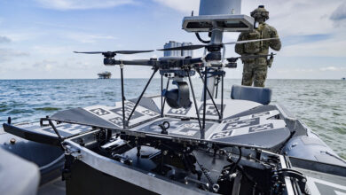 The SkyCarrier carrying a drone at sea with a soldier in the background
