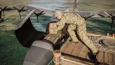 A soldier places supplies inside a Regent seaglider.