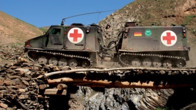 Command and transport vehicle BV 206 S (Husky /Hägglund) crosses a bridge in the mountains of Afghanistan.