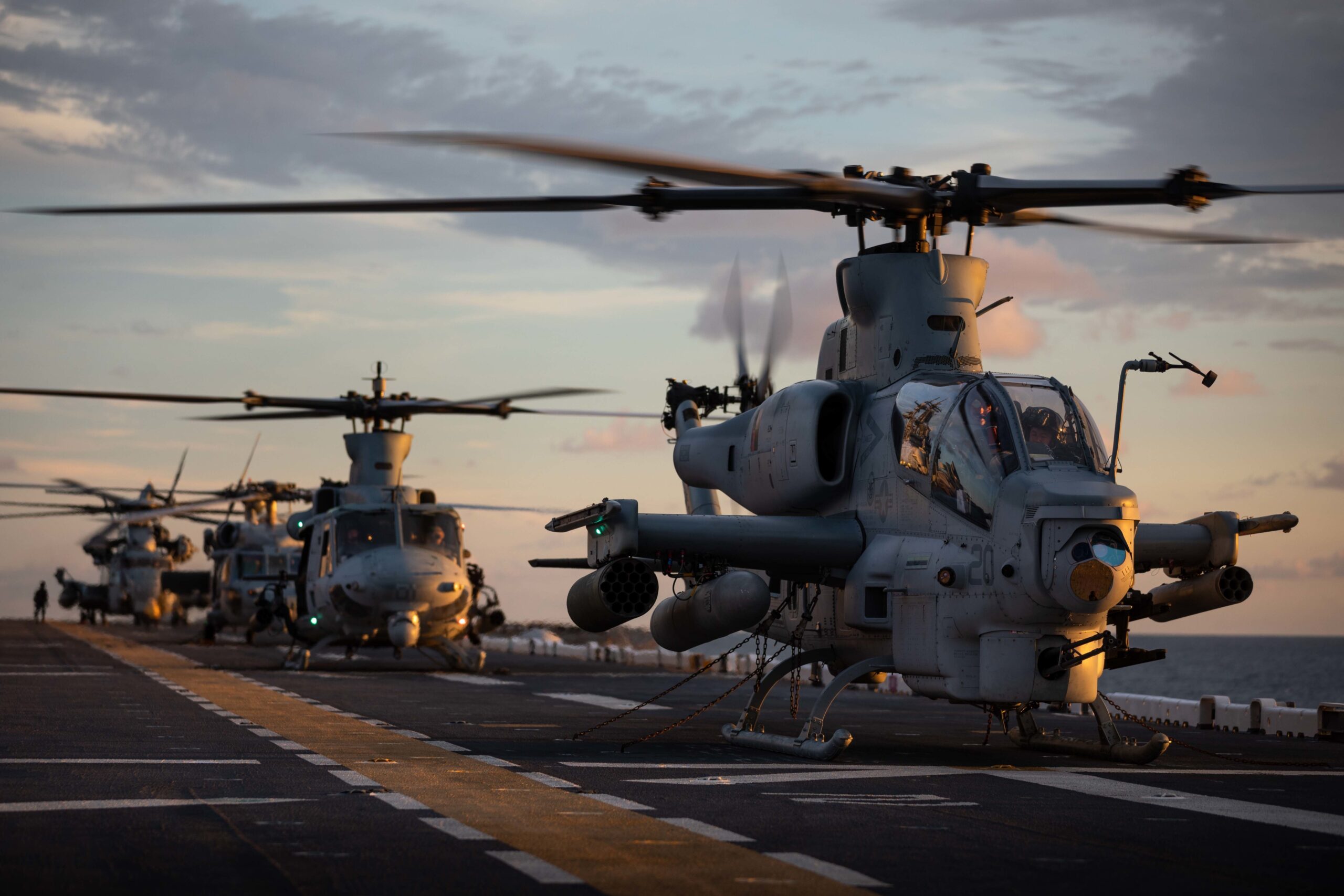 210818-N-MZ836-1491 ATLANTIC OCEAN (Aug. 18, 2021) From front to back, a AH-1Z Viper helicopter and UH-1Y Venom attached to Marine Light Attack Helicopter Squadron (HMLA) 167, a MH-60S Sea Hawk helicopter, attached to Helicopter Sea Combat Squadron (HSC) 28 and a CH-53E Super Stallion attached to Marine Heavy Helicopter Squadron (HMH) 461 idle on the flight deck of the Wasp-class amphibious assault ship USS Kearsarge (LHD 3) Aug. 18, 2021. U.S. Marine Corps, U.S. Army, and Navy helicopters integrate with U.S. Navy vessels to maintain flight deck landing and take-off proficiencies and qualifications. (U.S. Navy photo by Mass Communication Specialist 3rd Class Jesse Schwab)