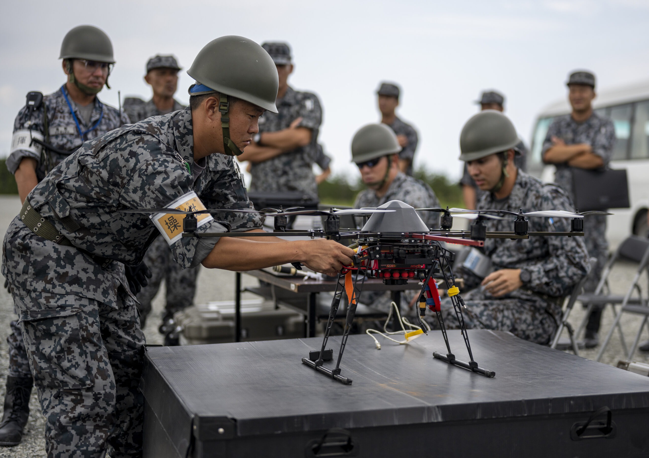 A Japan Air Self-Defense Force Airman assigned to the Western Air Civil Engineering Group sets up a drone during a bilateral live fire exercise at Draughon Range near Misawa Air Base, Japan, July 18, 2023. U.S. and Japanese partners worked together, repairing the craters and exchanging knowledge while observers from both countries watched. (U.S. Air Force photo by Senior Airman Anwtain Hanks)