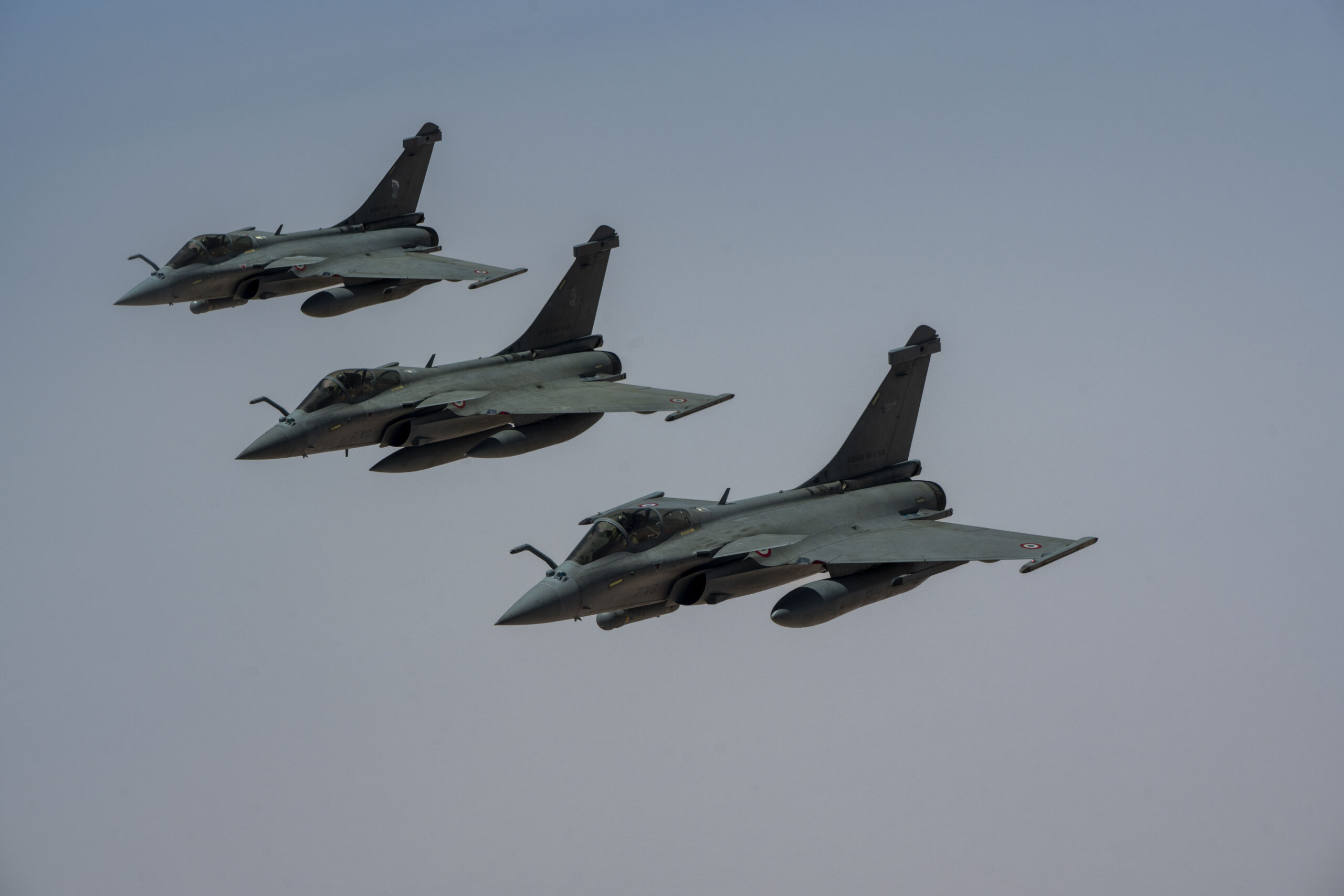 Three French Air and Space Force Dassault Rafales fly in formation behind a U.S. KC-135 Stratotanker over the U.S. Central Command area of responsibility, Aug. 20, 2025. The U.S. participated in a multinational exercise with the French Air Force to strengthen partner integration and foreign relations. (U.S. Air Force photo by Senior Airman Natalie Jones)