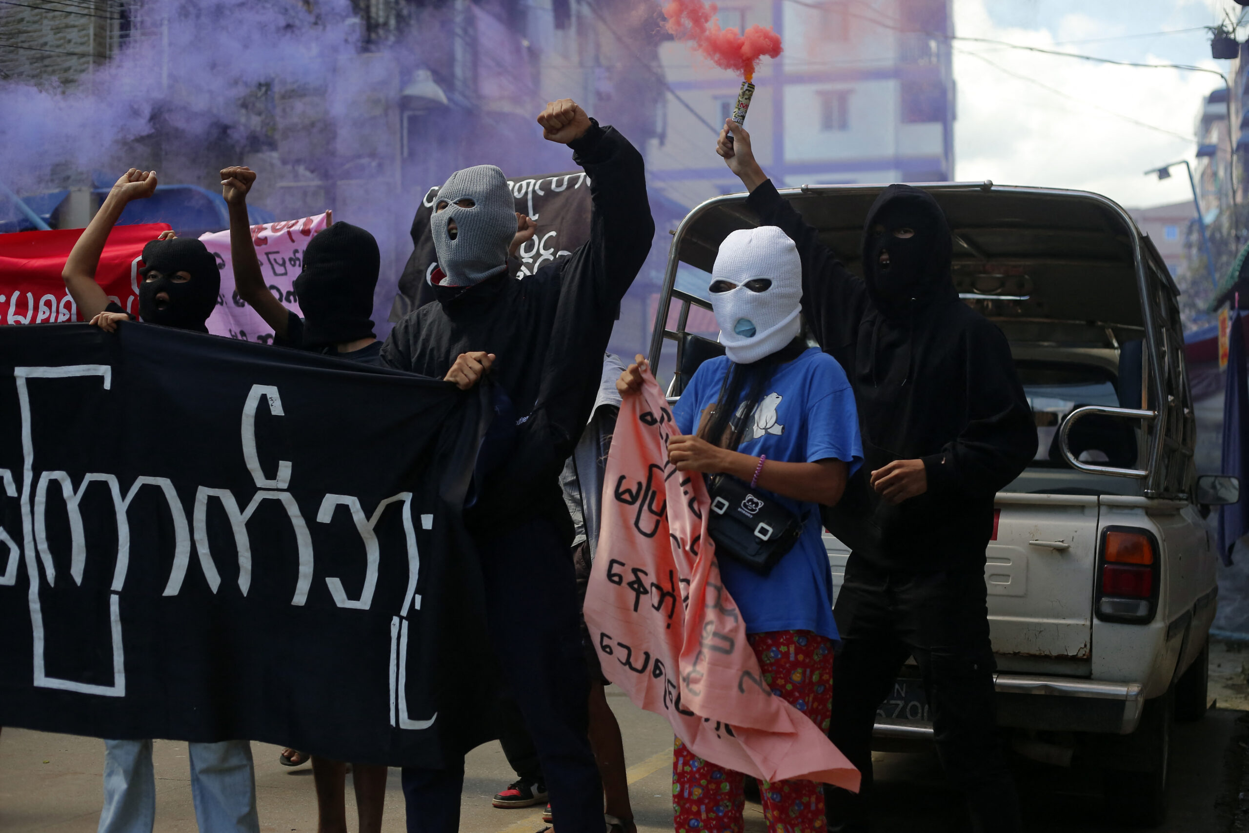 Young demonstrators shout slogans and hold flares during an anti-coup protest in Yangon, Myanmar on July 25, 2022. Myanmars military junta on July 25, 2022, reported the execution of four political prisoners in the countrys first death sentences carried out in over 30 years. (Photo by STR/NurPhoto) (Photo by NurPhoto via AFP)