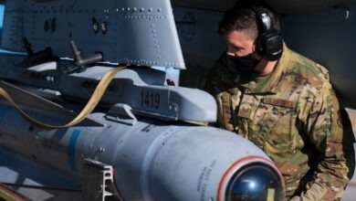 U.S. Air Force Tech. Sgt. Kacey Johnson, a weapons load crew member assigned to the 122nd Fighter Wing, Indiana Air National Guard, installs an AGM-65 Maverick missile on an A-10C Thunderbolt II aircraft during Red Flag 21-1 at Nellis Air Force Base, Nevada, Feb. 4, 2021.