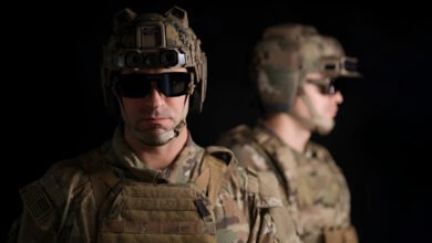 A soldier and his reflection shown wearing Anduril's EagleEye system against a black background