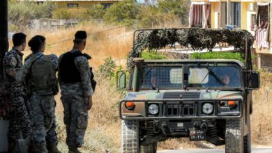A Lebanese army vehicle approaches soldiers stationed near the Ain al-Hilweh camp for Palestinian refugees in Lebanon's southern city of Sidon.