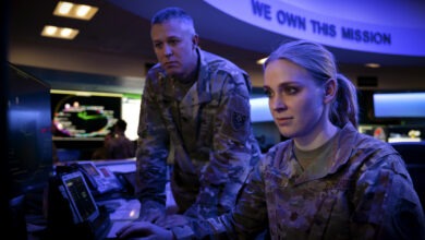 U.S. Army Lt. Col. Claude Lambert, chief of future operations division for the Joint Task Force-Space Defense and U.S. Air Force Maj. Katie “Starbuck” Baier, chief of intelligence for weapons and tactics for the JTF-SD, look at a computer screen at Schriever Space Force Base, Colorado, Dec. 19, 2022. Through the partnering of the Department of Defense, Intelligence Community and National Reconnaissance Office in the National Space Defense Center, JTF-SD brings to bear the full force of the U.S. Government and synchronizes space superiority planning and operations. (U.S. Space Force photo by Dennis Rogers)