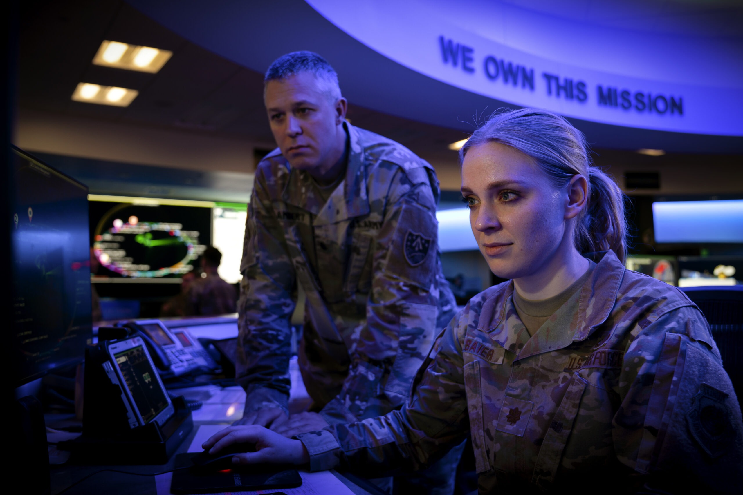 U.S. Army Lt. Col. Claude Lambert, chief of future operations division for the Joint Task Force-Space Defense and U.S. Air Force Maj. Katie “Starbuck” Baier, chief of intelligence for weapons and tactics for the JTF-SD, look at a computer screen at Schriever Space Force Base, Colorado, Dec. 19, 2022. Through the partnering of the Department of Defense, Intelligence Community and National Reconnaissance Office in the National Space Defense Center, JTF-SD brings to bear the full force of the U.S. Government and synchronizes space superiority planning and operations. (U.S. Space Force photo by Dennis Rogers)