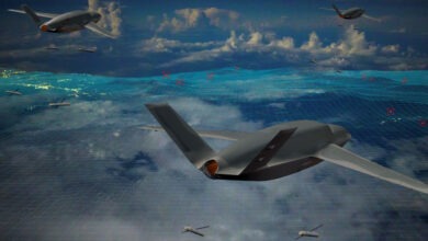 A formation of Gambit 6 drones flying in the sky above the ocean, showcasing their sleek designs against the blue backdrop.