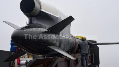 Workers and military inspect Ukrainian Fire Point's Flamingo missiles during handover to the military in an undisclosed location in Ukraine Thursday, Dec. 4, 2025. (AP Photo/Efrem Lukatsky)