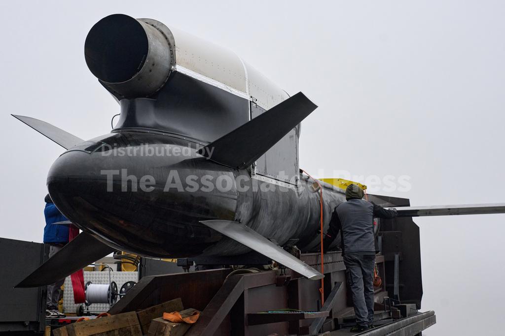 Workers and military inspect Ukrainian Fire Point's Flamingo missiles during handover to the military in an undisclosed location in Ukraine Thursday, Dec. 4, 2025. (AP Photo/Efrem Lukatsky)