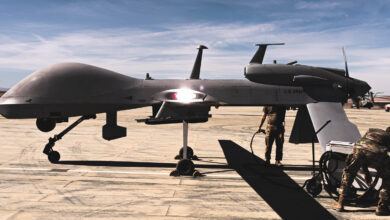 U.S. Army soldiers with 1st Attack Reconnaissance Battalion, 1st Aviation Regiment, 1st Combat Aviation Brigade, 1st Infantry Division, conduct pre-flight checks on an MQ-1C Gray Eagle during the Battalion Distributed Operations Course at Marine Corps Air Ground Combat Center, Twentynine Palms, Oct. 20, 2021. The soldiers integrated seamlessly with U.S. Marines on the ground and in the sky, providing ground commanders with superior reconnaissance, overwatch, and marking targets by laser for the Aviation Combat Element whilst maintaining the ability to utilize their own AGM-114 Hellfire Missile. (U.S. Marine Corps photo by Lance Cpl. Shane T. Beaubien)